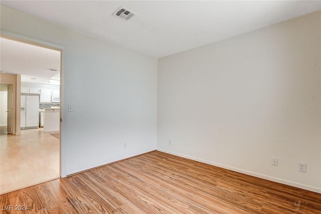 empty room with light hardwood / wood-style floors