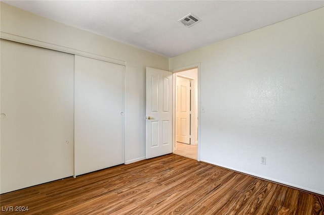 unfurnished bedroom featuring a closet and light wood-type flooring