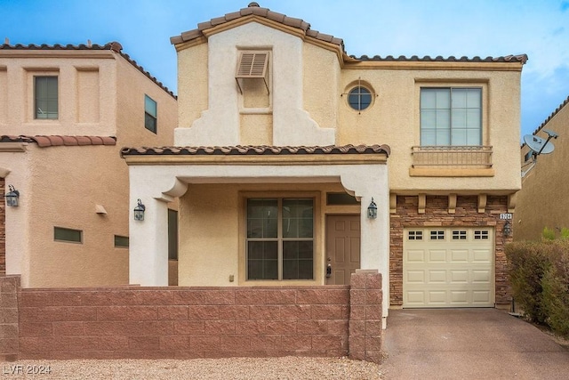 mediterranean / spanish-style home with a garage