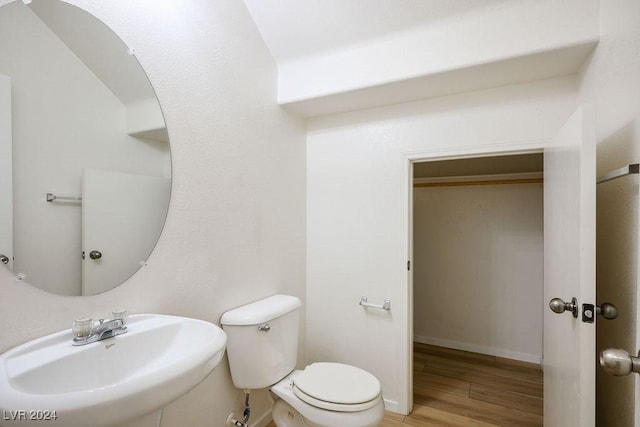 bathroom featuring hardwood / wood-style floors, toilet, and sink