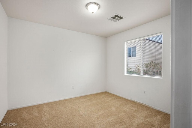 spare room with light carpet