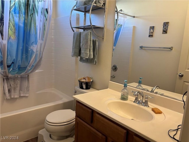 bathroom with bathtub / shower combination, vanity, and toilet