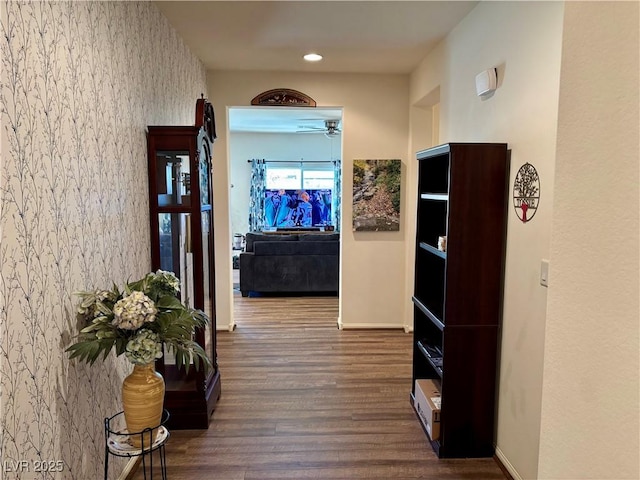 hall with recessed lighting, wallpapered walls, baseboards, and wood finished floors