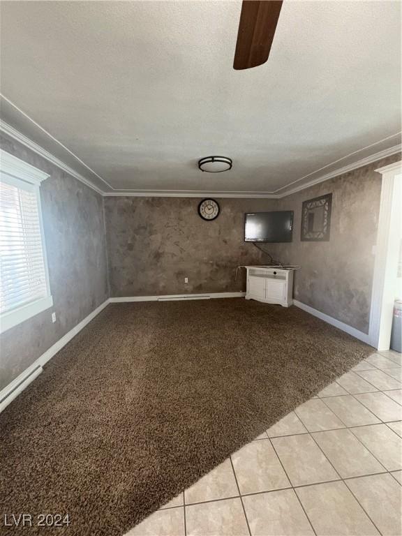 spare room with light tile patterned floors and ornamental molding