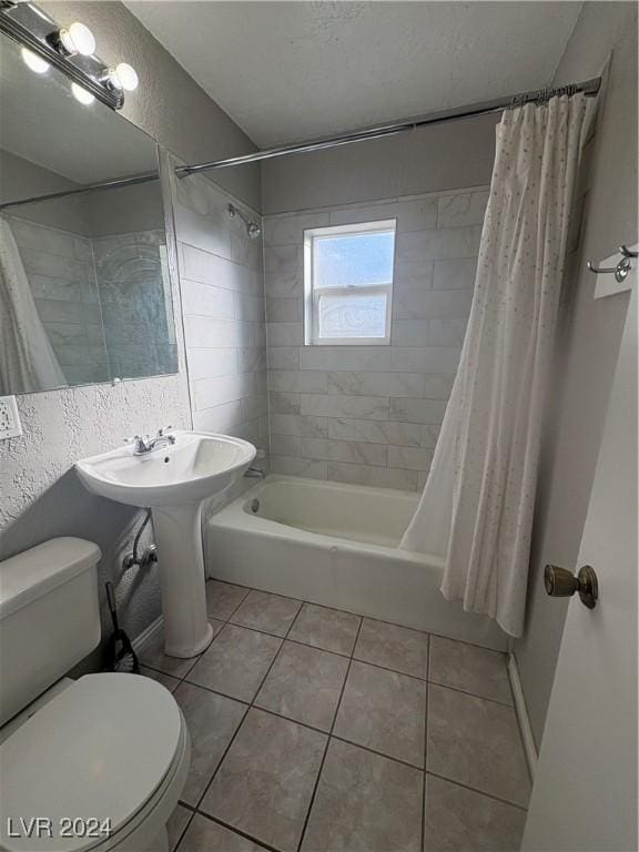 bathroom featuring tile patterned flooring, shower / tub combo, a textured ceiling, and toilet