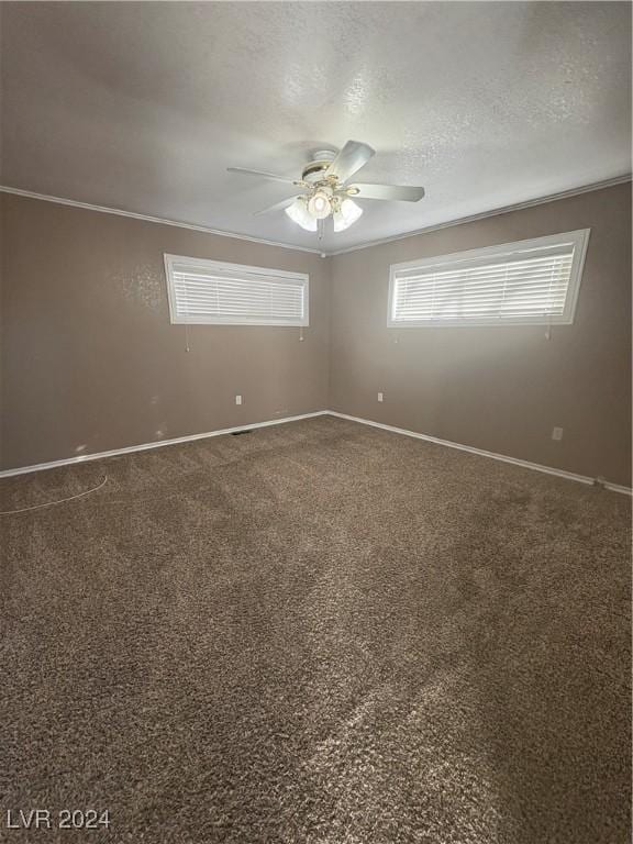 spare room with a textured ceiling, ceiling fan, and crown molding