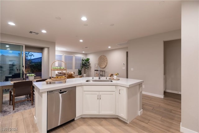 kitchen featuring stainless steel dishwasher, light hardwood / wood-style floors, white cabinets, and a kitchen island with sink