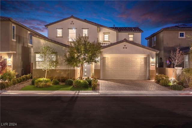 mediterranean / spanish-style home featuring a garage