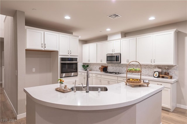 kitchen featuring white cabinetry, an island with sink, and appliances with stainless steel finishes