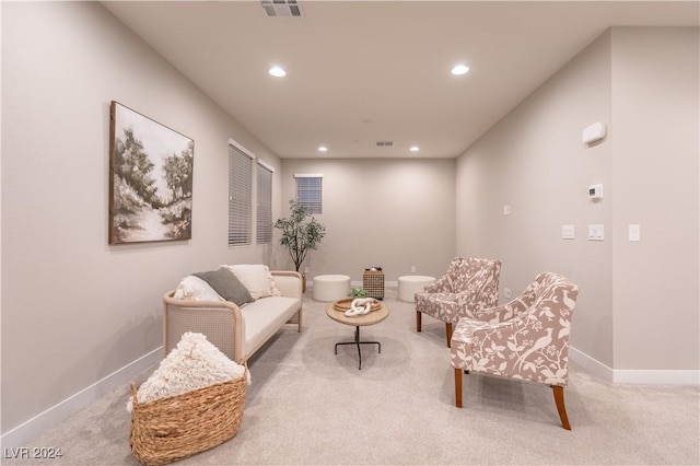 sitting room featuring light carpet