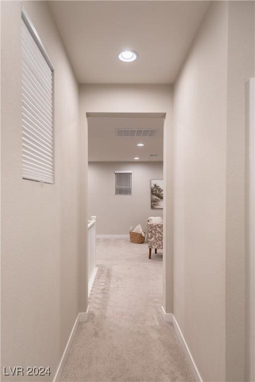 hallway featuring light carpet