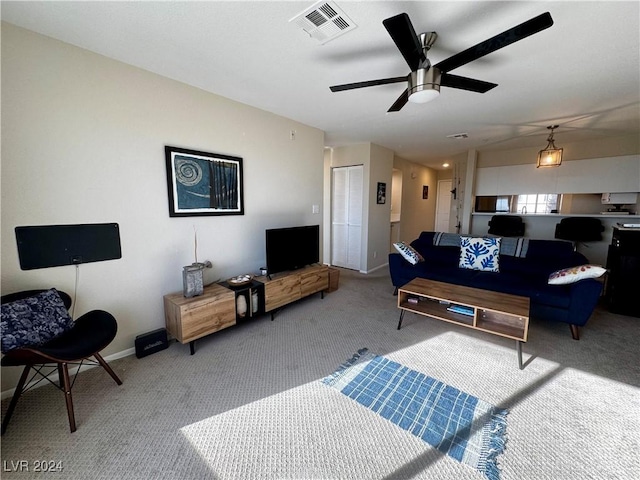 carpeted living room with ceiling fan