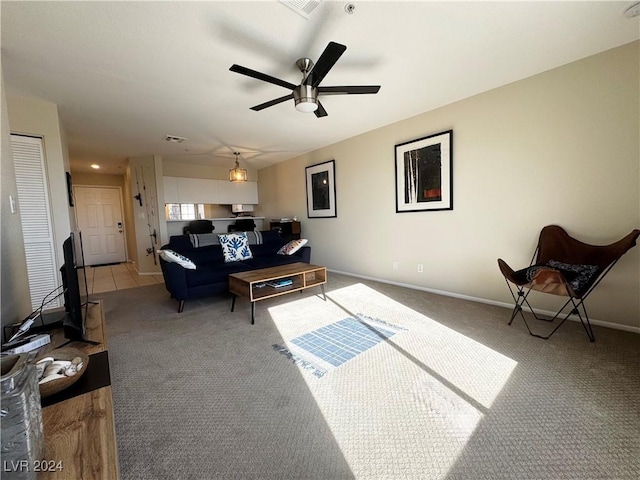 carpeted living room featuring ceiling fan