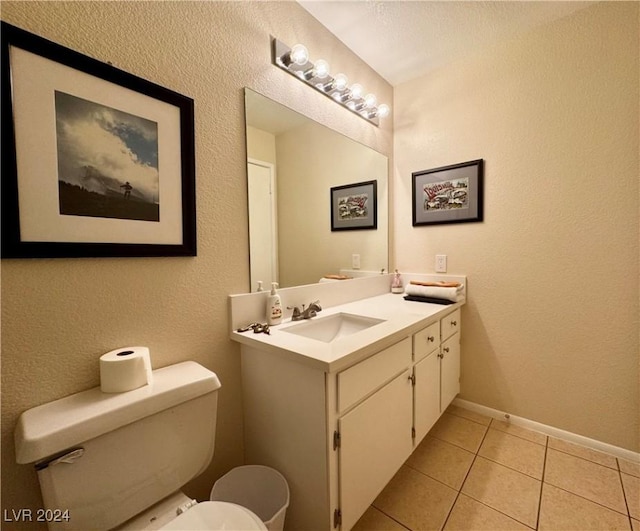 bathroom featuring tile patterned floors, vanity, and toilet