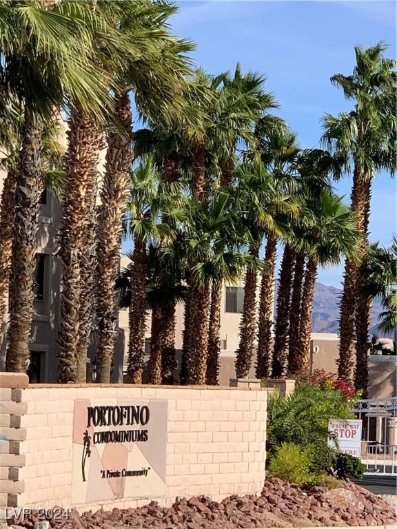 community / neighborhood sign with a mountain view