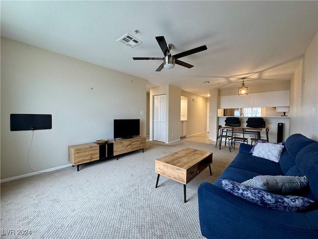 living room with baseboards, light carpet, a ceiling fan, and visible vents
