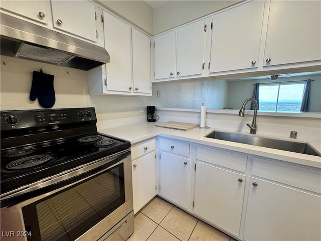 kitchen featuring a sink, light countertops, under cabinet range hood, electric stove, and light tile patterned floors