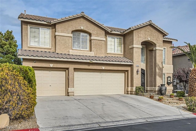 mediterranean / spanish-style home with a garage