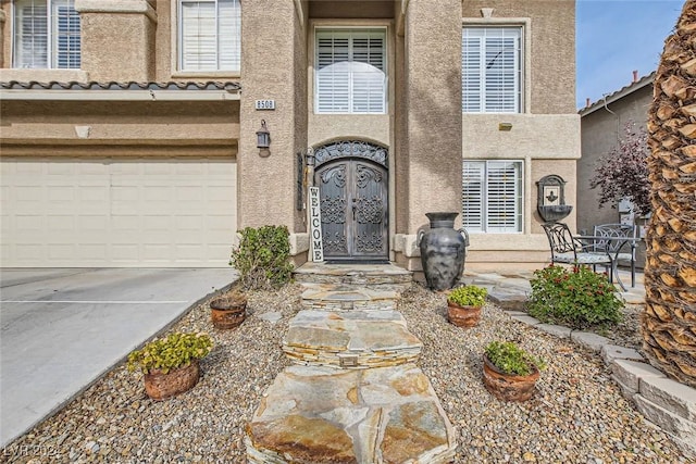 doorway to property with a garage