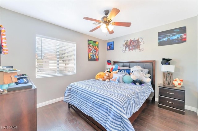 bedroom with dark hardwood / wood-style flooring and ceiling fan