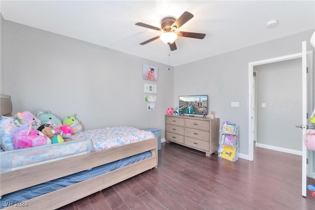 bedroom with dark hardwood / wood-style flooring and ceiling fan