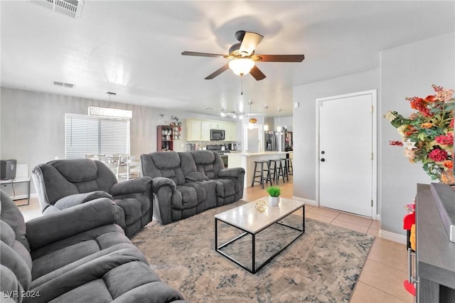 living room with ceiling fan and light tile patterned floors