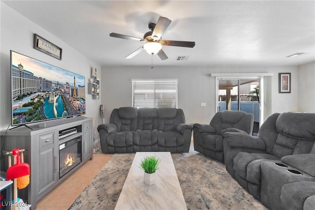 living room featuring ceiling fan and light tile patterned floors