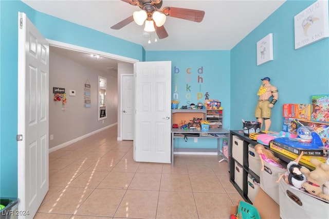 recreation room with ceiling fan and light tile patterned floors