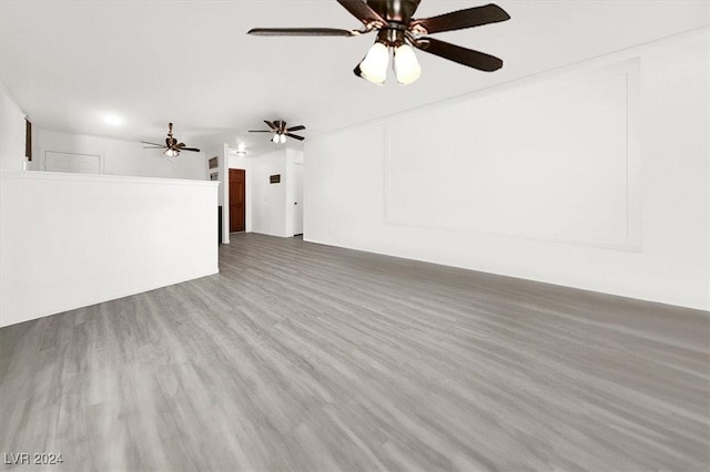 unfurnished living room with ceiling fan and hardwood / wood-style flooring