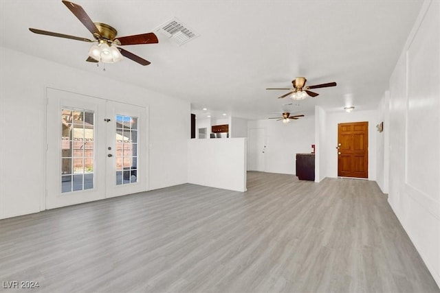 unfurnished living room with french doors, ceiling fan, and wood-type flooring