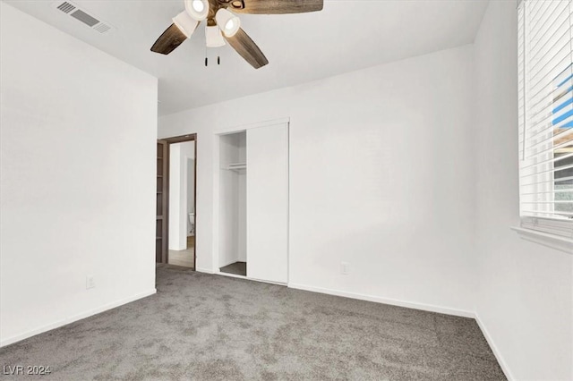 unfurnished bedroom with ceiling fan, a closet, and light colored carpet