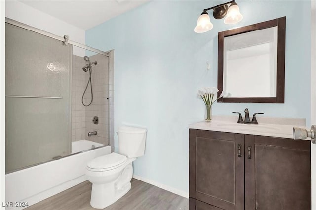 full bathroom featuring enclosed tub / shower combo, vanity, wood-type flooring, and toilet