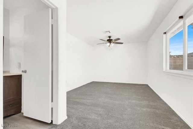 unfurnished room with ceiling fan and carpet floors