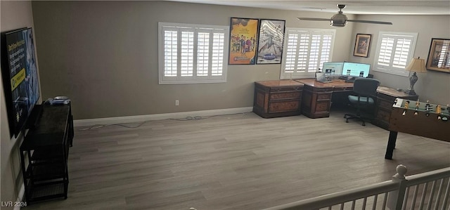 home office with ceiling fan and light hardwood / wood-style floors