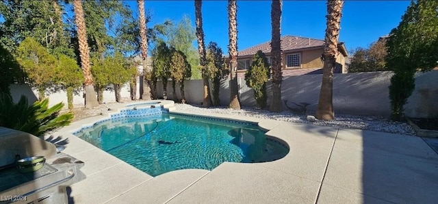 view of swimming pool with a patio area and an in ground hot tub