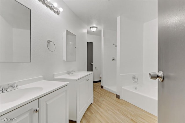 bathroom featuring vanity, toilet, and wood-type flooring