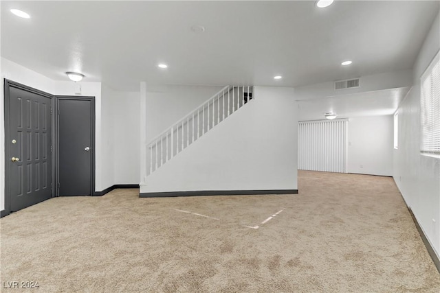 unfurnished living room with light carpet