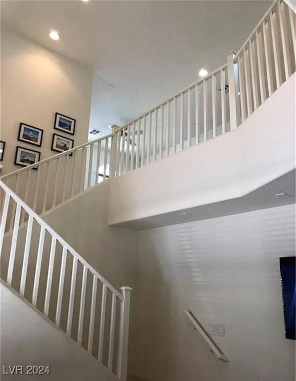 staircase with a towering ceiling