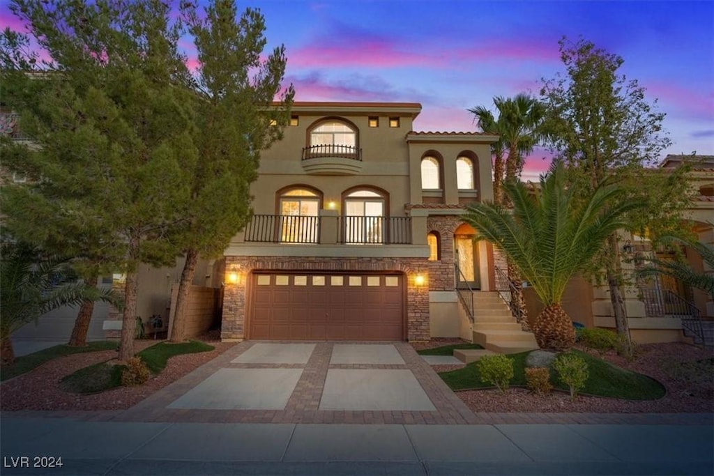 mediterranean / spanish-style house featuring a balcony and a garage