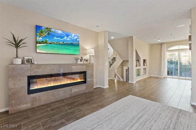 living room featuring a tiled fireplace