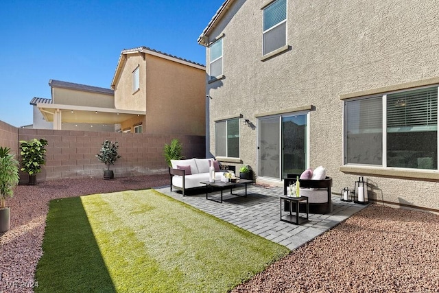 back of property with an outdoor hangout area and a patio