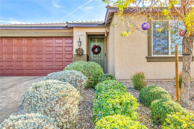 view of exterior entry with a garage