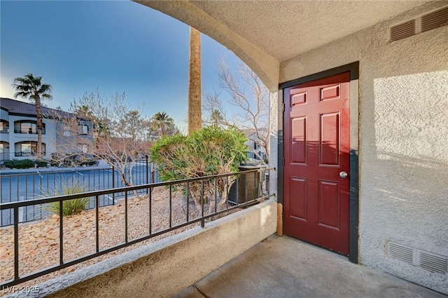 entrance to property featuring a balcony and central AC