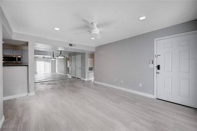 unfurnished living room with ceiling fan