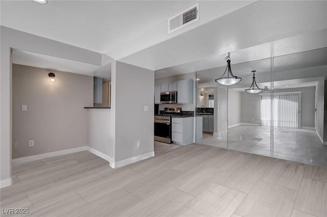 unfurnished living room with sink and light tile patterned flooring