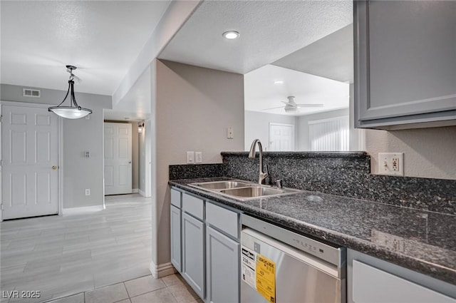 kitchen with sink, hanging light fixtures, stainless steel dishwasher, ceiling fan, and light tile patterned flooring