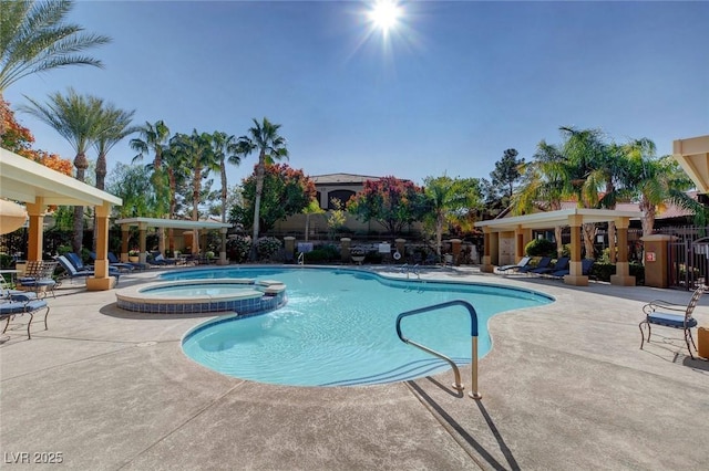 view of swimming pool with a patio area and a hot tub