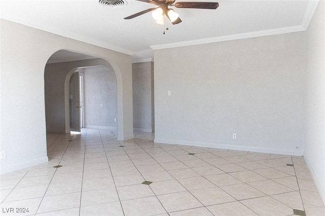 tiled empty room featuring ceiling fan and crown molding