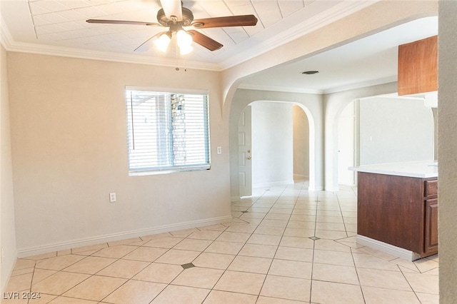 unfurnished room with ceiling fan, ornamental molding, and light tile patterned floors