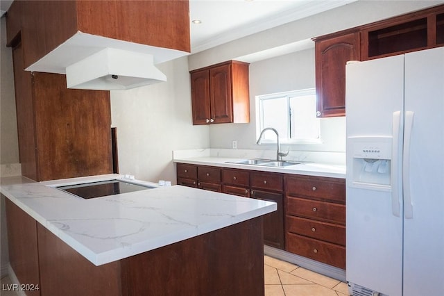 kitchen with kitchen peninsula, sink, light tile patterned floors, stovetop, and white fridge with ice dispenser